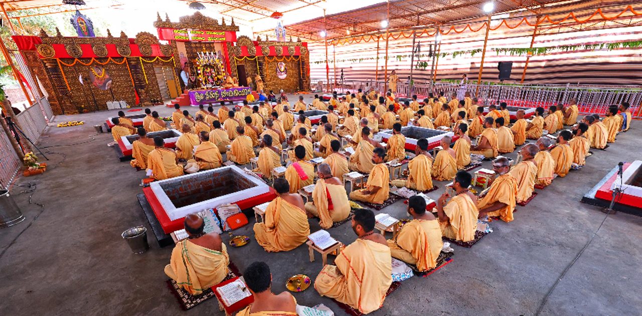Priests seated around sacred fire kundas during a yaaga at Rama Śakti Mission